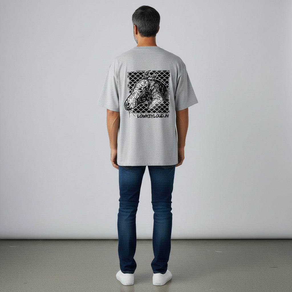 Person wearing a gray t-shirt with a graphic design on the back, standing against a plain background.