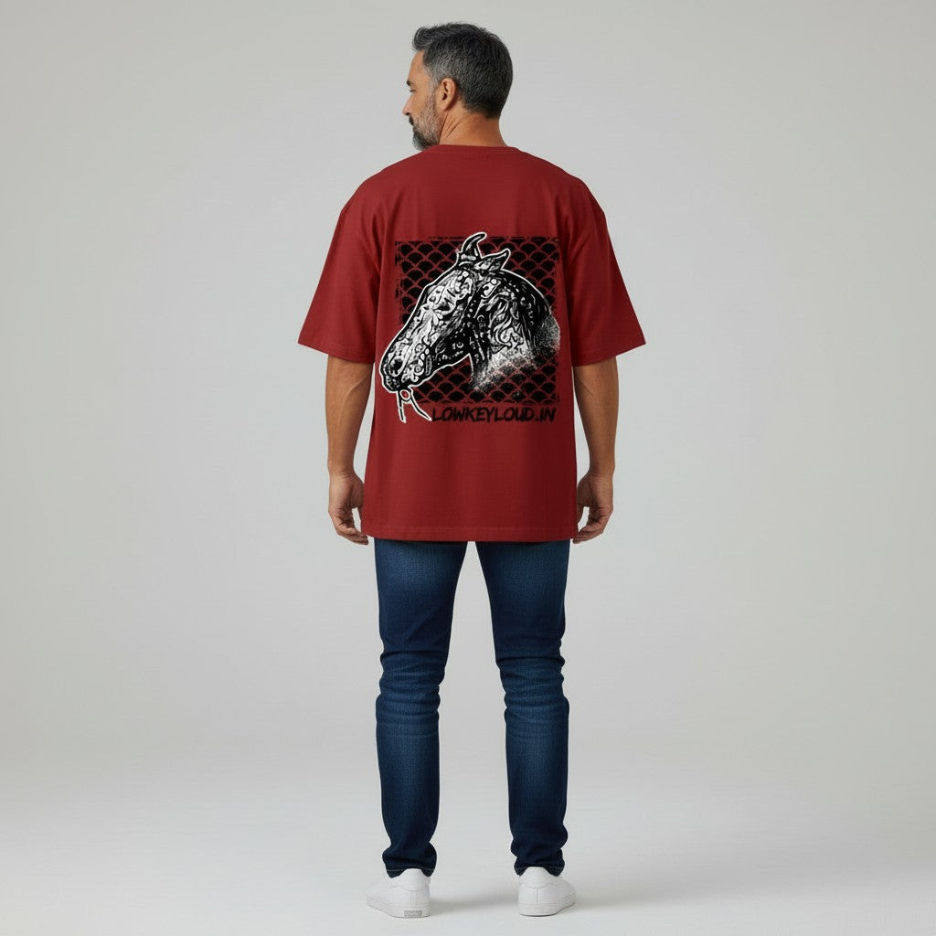 Man wearing a red t-shirt with a graphic design on the back, standing against a plain background